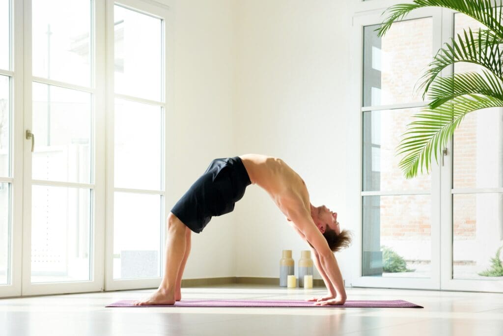 Man practicing yoga doing bridge pose