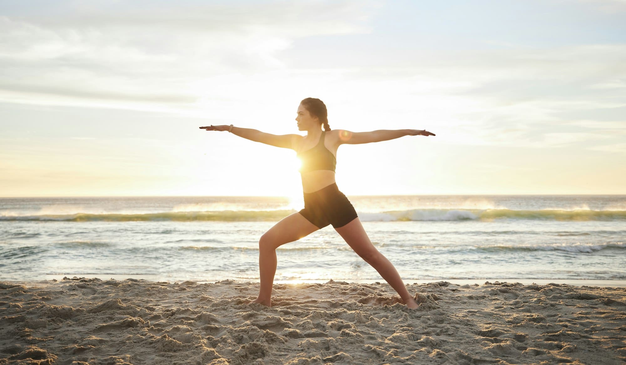 Woman, yoga and meditation on the beach for zen, spiritual wellness or workout in the sunset outdoo