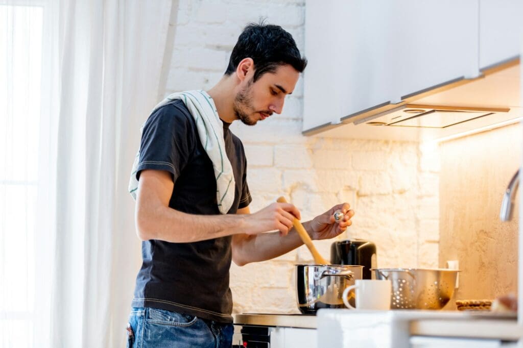 Young man cooking at home.